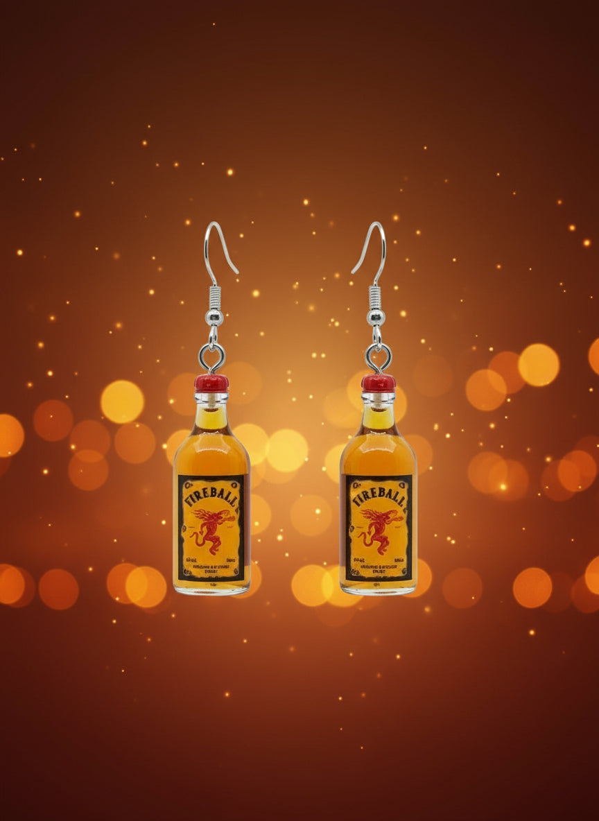 Fireball bottle-shaped earrings on a black card with a wooden stand.