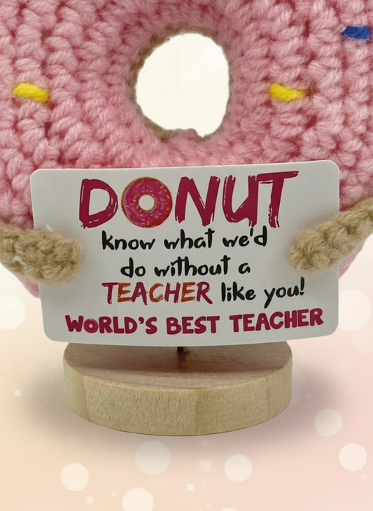 Donut-shaped plush toy with a sign