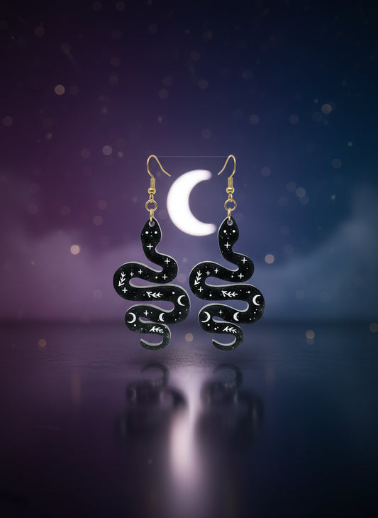 Black and gold jewelry set on a display card against a white background