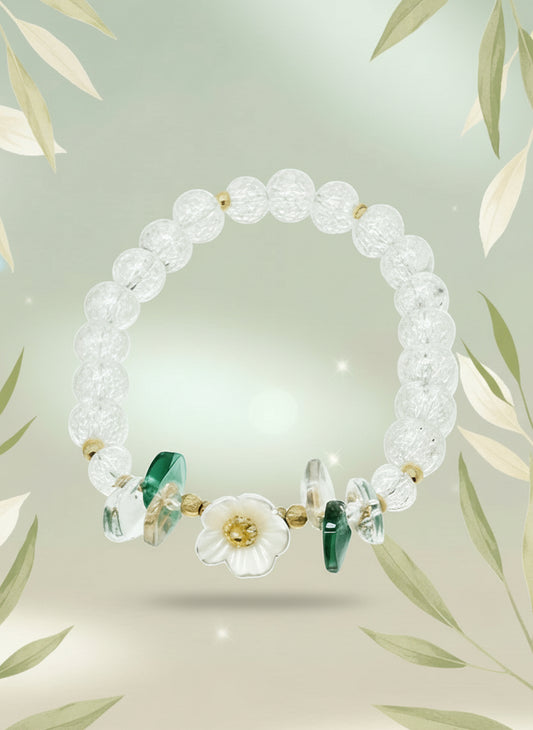 Beaded bracelet with gold and green accents on a white background
