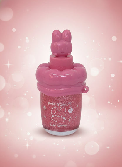 FANTYCHIC Gloss Lip Shine – Clear Sparkle Lip Gloss in Rabbit Tube on a pink background with sparkling effects.