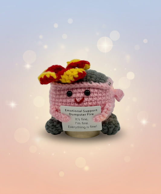 Crocheted plush toy with flowers on a white background