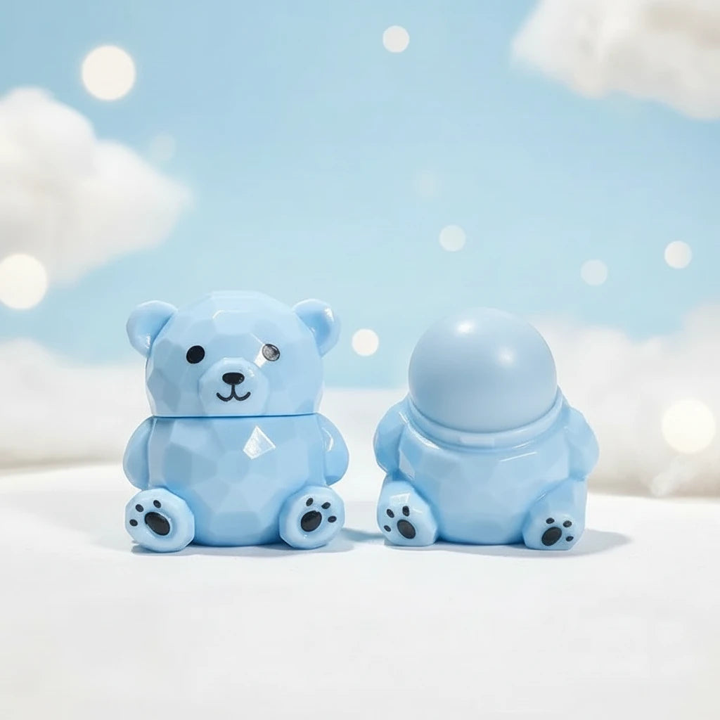 Bear Magic Lip Balm in a cute blue bear shape against a dreamy background, showcasing color-changing lip gloss.