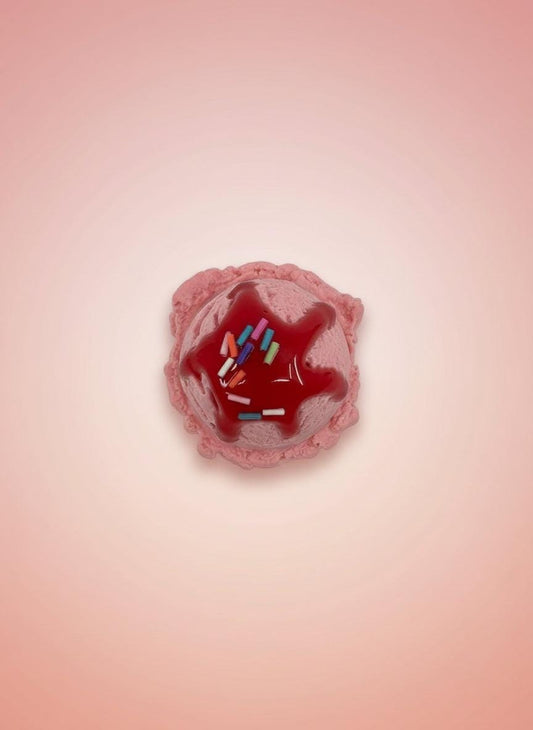 Realistic Fake Ice Cream Magnet in cherry flavor with colorful sprinkles on a pink background.