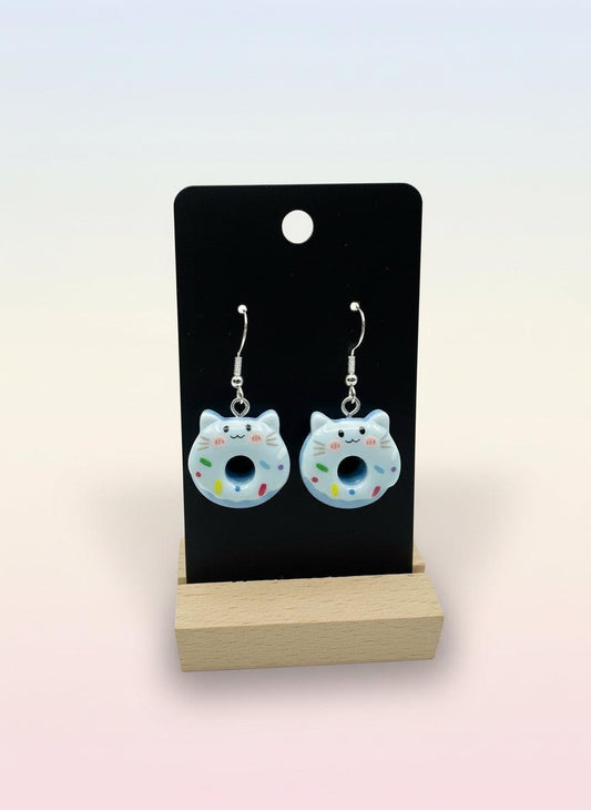 Cute Animal Donut Earrings featuring adorable cat designs with blue icing and colorful sprinkles on display.
