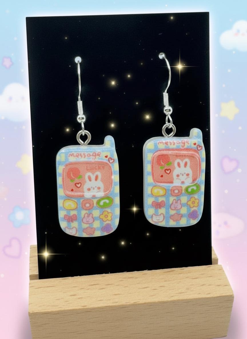 Adorable Kawaii Phone Earrings featuring cute cartoon phone designs with colorful characters and glossy resin finish.