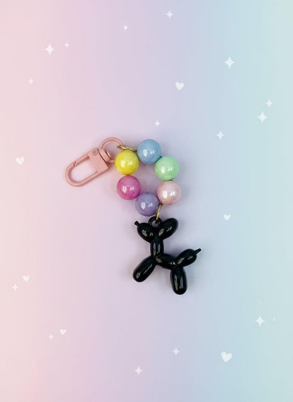 Keychain with balloon dog charm and colorful beads on a white background