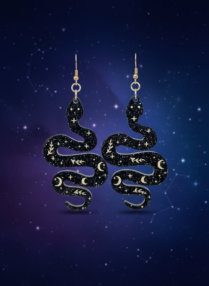 Black glitter snake-shaped earrings on a wooden stand with a black background