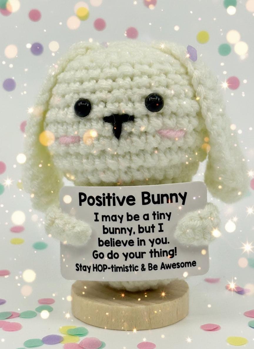 Crocheted bunny with a motivational message on a white background