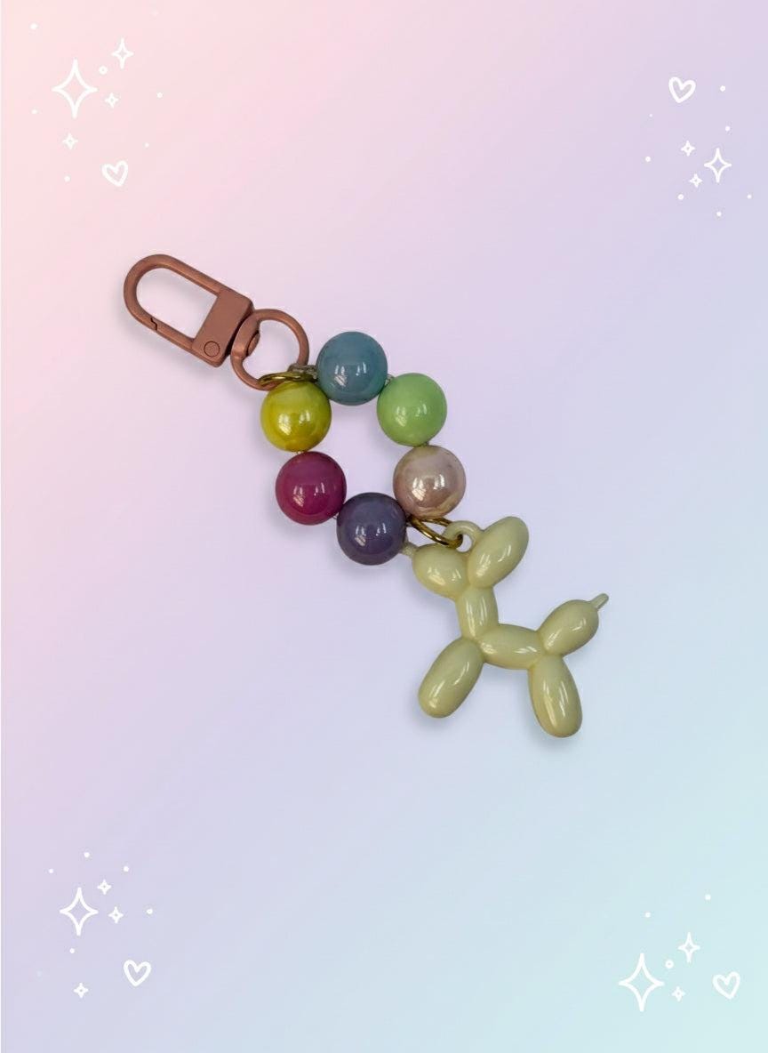 Keychain with colorful beads and balloon dog charm on a light gray background