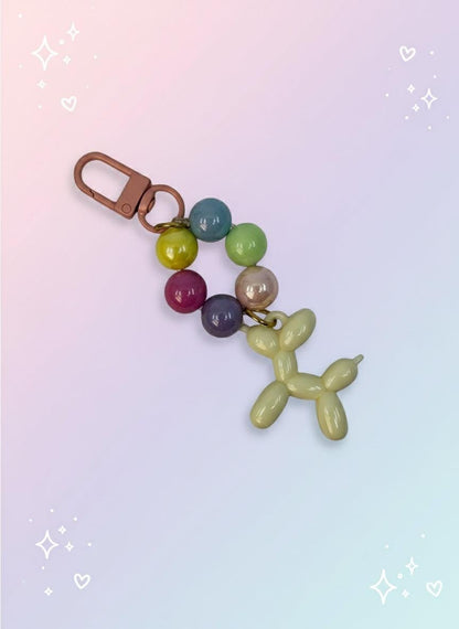 Keychain with colorful beads and balloon dog charm on a light gray background