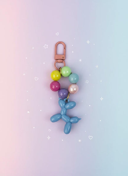 Keychain with colorful beads and a blue balloon dog charm on a white background