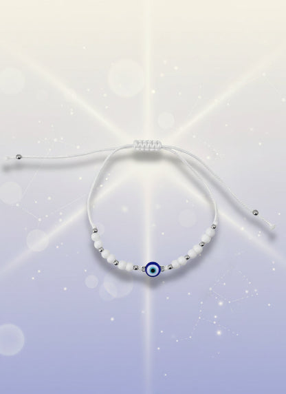 Yellow beaded bracelet on a white background with a brown card