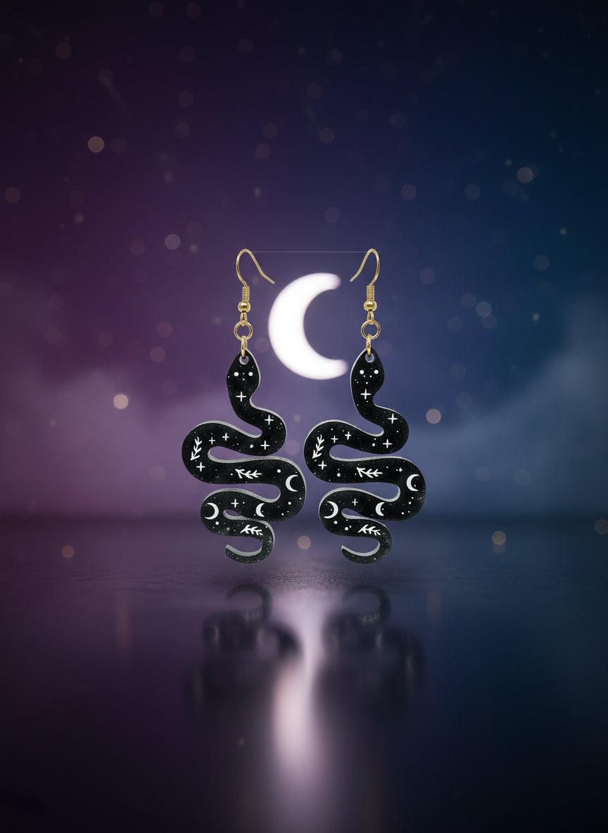 Black and gold jewelry set on a display card against a white background