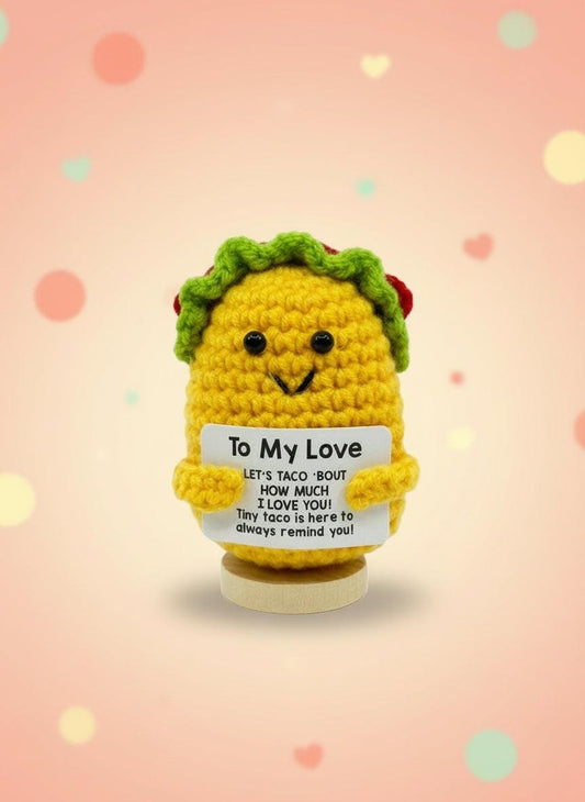 Yellow crochet taco with a message card on a white background